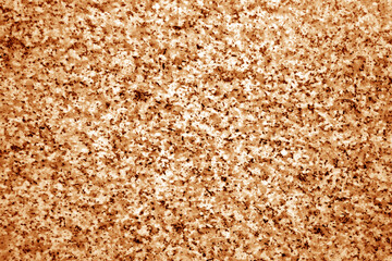 Granite surface as background with blur effect in orange tone.