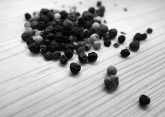 Mixture of peppers on wooden cutting board in black and white