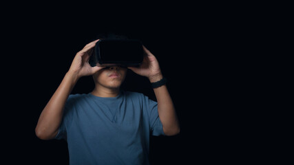 Man wearing virtual reality Headset on black background.