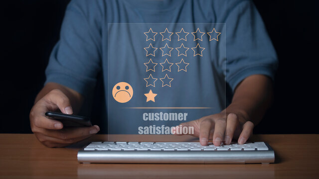 Man use smartphone and keyboard computer choosing sadness emotion face screen. bad service dislike bad quality, low rating, social media not good. Concept of customer experience dissatisfied.