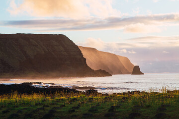 Cliffs in the Pacific Ocean on Easter Island at sunrise