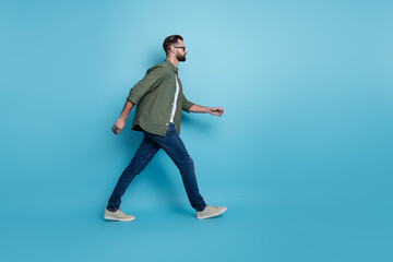 Profile photo of intelligent employee guy walk career steps wear specs green shirt jeans isolated blue color background