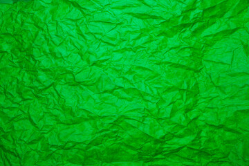 Textured green paper background.