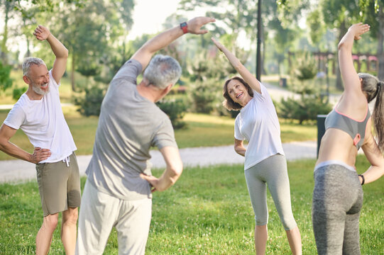 Group of people doing morning exercises in the park