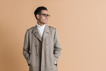 Young middle eastern man in eyeglasses smiling and looking aside