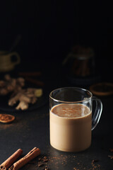 A cup with masala chai in low key	