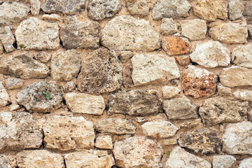 Close-up of a street brown   antique wall with raised details. Tile pattern