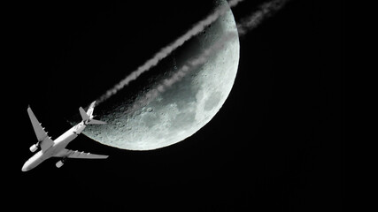 plane passing in front of waxing crescent moon