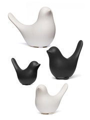 Detail shot of figurines of black and white matte birds with raised tails.  The porcelain...