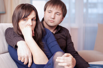 Family Issues. Caucasian Couple Sitting With Sad Emotions Embraced.