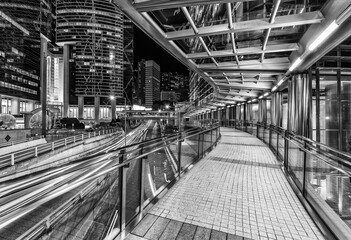 Night scenery of modern pedestrian walkway in downtown district of Hong Kong city