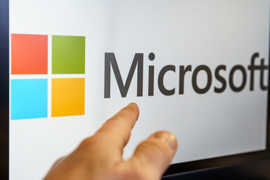 Microsoft logo on screen. Microsoft Corporation is an American multinational technology corporation which produces computer software, consumer electronics, personal computers,