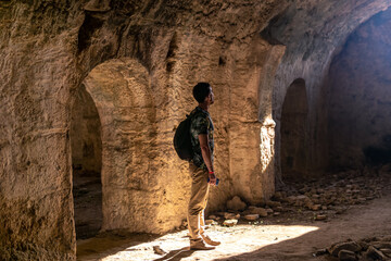 tourist visiting the dungeons in the ruins of ancient hospital in Side, Turkey