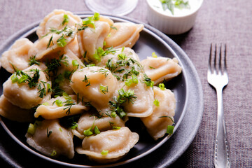 Dumplings with potatoes and sour cream. Vareniki is a dish of Slavic cuisine.