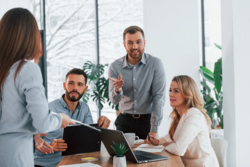 Sharing some ideas. Group of business people that working on the project in the office