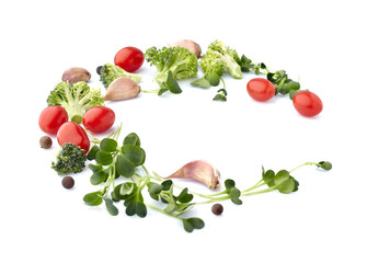 Fresh vegetables on the white background with pepper. Cherry tomatoes with broccoli, garlic and sprouts closeup.