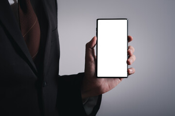 Close up hands of business man holding smartphone with white screen. social communication technology concept. Work on mobile phone application.