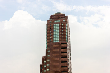 A tall tower of a skyscraper housing business office blocks in downtown Kuala Lumpur.