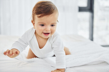 Fototapeta premium Having fun. Cute little baby is indoors in the domestic room