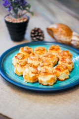 Cashew Nut Cookies placed on a sea-green art-painted plate.