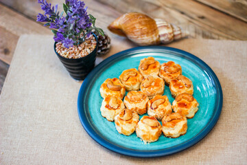 Cashew Nut Cookies placed on a sea-green art-painted plate.