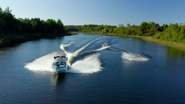 Wakeboarding behind a boat on a lake in Michigan