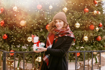 Christmas. Girl in winter clothes at the Christmas market. 