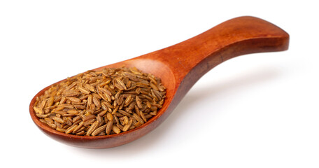 Roasted cumin seeds in the wooden spoon, isolated on the white background.