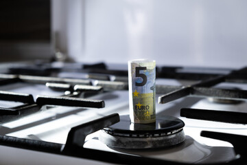 No flame. Concept of gas crisis. 5 euro bank note on a stove. Cash money. High prices of natural...