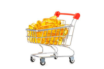 Fish oil soft gel supplement capsules in mini supermarket push cart isolated on white background
