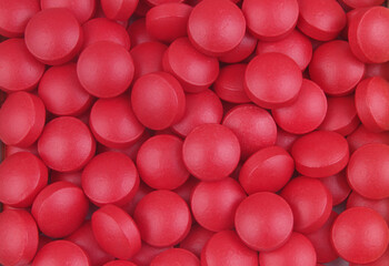 Many red drugs close up.