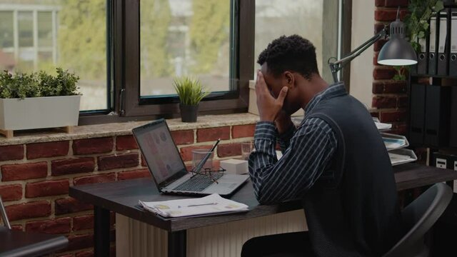 Stressed employee failing to do financial presentation on laptop, feeling desperate and under pressure. Worker with career problem finding out bad news and worrying about failure.