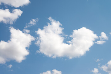 Smooth white clouds on clear blue sky background and copy space. Outdoor nature or save the earth concept.