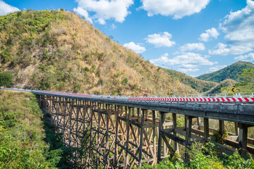 Huai tong concrete long and tall highway bridge in forest winter season, Phetchabun Thailand. Transportation and construction concept.