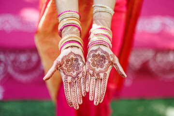 Beautiful Mehndi design on hand young bride's hands with henna Hands with traditional Indian henna...