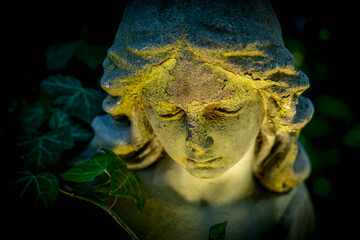 Crying angel of death. Retro styled ancient statue of sad angel as symbol of pain, fear and end of...