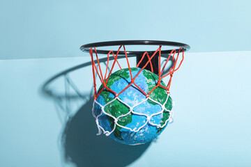 Small Earth ball in basketball hoop