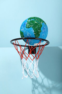 Small Earth ball in basketball hoop