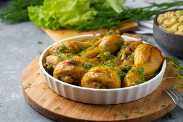 Fried tasty chicken drumstick served in white bawl with spices