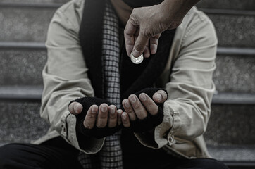 Close-up of the poor or homeless Homeless people ask for money in public. The poor beggar in the...