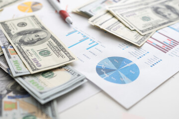 Fototapeta premium money concept, graph, chart document and pen on desktop.