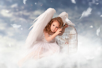 a cute charming girl in an angel costume with huge wings sits on a cloud on Valentine's Day or...