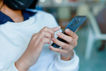 female hand holding a smartphone Technology concepts and communication devices