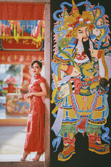 Fototapeta na wymiar Beautiful Asian Chinese Woman Wearing Cheongsam Traditional Red Dress Fashion Posting Chinese Lunar New Year.