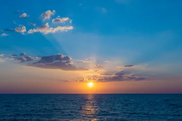 Gardinen Beautiful sunset with blue sea as for summer travel background. © newroadboy