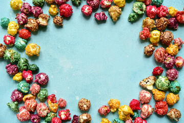 Food background with colorful caramel candy popcorn . Top view with copy space.