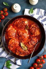 Chicken thighs stewed in tomato sauce. Top view with copy space.