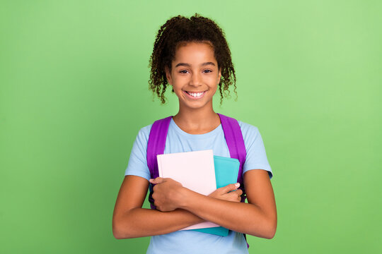 Photo of young afro girl happy smile hold boook education school lesson isolated over green color background