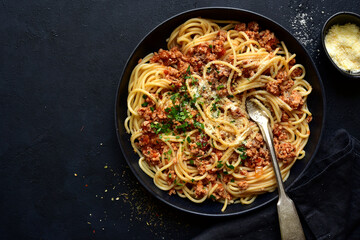 Traditional italian spaghetti bolognese with minced meat and tomato sauce. Top view with copy space.