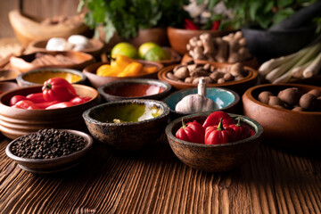 Thai food background. Ingredients in teak bowls on rustic wooden table.